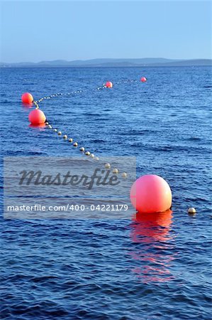several buoys marking a safe way for boats