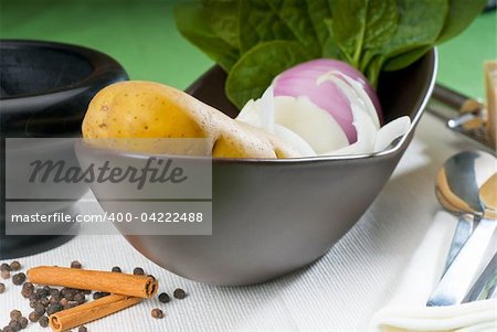 bowl of fresh vegetable with spice and mortar beside,basic ingredients for a soup recipe