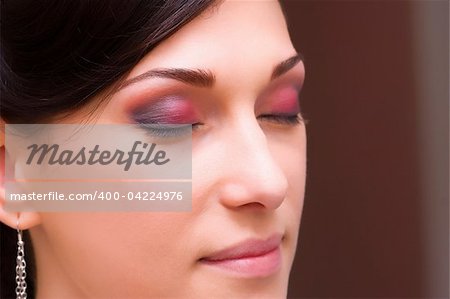 beautiful brunette young lady closeup prepared for the event by makeup artist