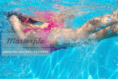 underwater pink bikini little girl swimming in blue pool