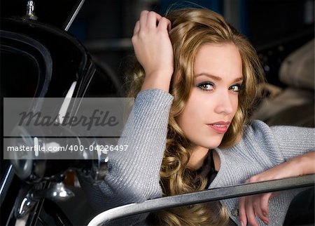 pretyy young woman in an old car