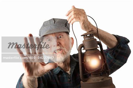 Apprehensive railroad man holding a glowing red lantern.