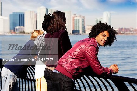 An African American looking at the camera with a group of friends in the background