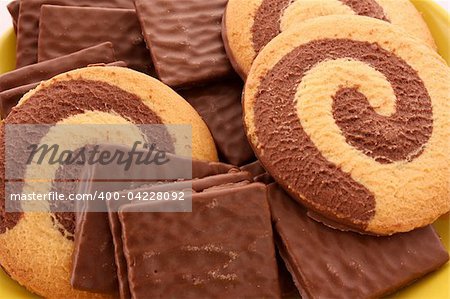 Chocolate cookie and cup of coffee on red background