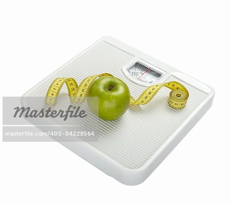 close up of scale, tape and apple on white background with clipping path