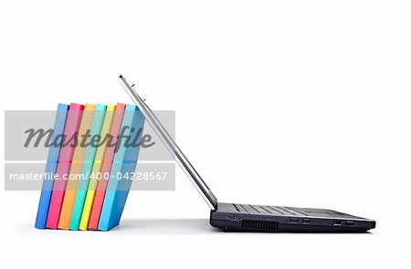 close up of stack of colorful books and laptop on white background, with clipping path included