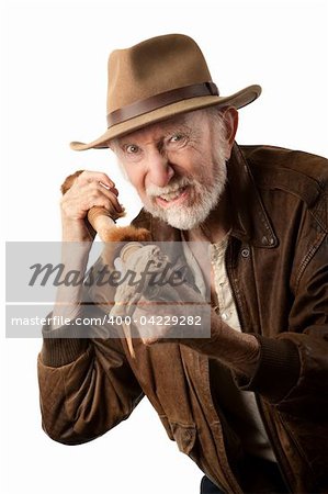 Adventurer or archaeologist in brown leather jacket defending himself with abcient weapon