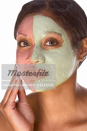 Woman with special facial mask applied on her face. The mask consist of two colors (red and green), each cover different part