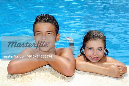 teen boy and little girl summer vacation in blue swimming pool