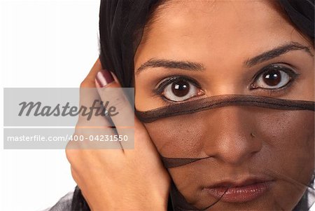 Young middle eastern woman looking at the world from behind a veil