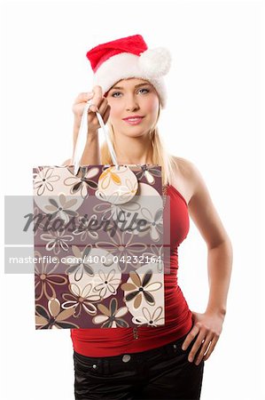 young blond woman with red top and a christmas hat keeping a shopping bag and smiling in camara