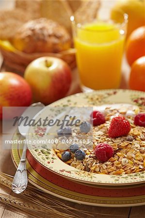 muesli with fresh berries, apples and orange juice