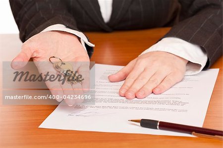 Business woman holds key and contract in hands. Isolated on white background.