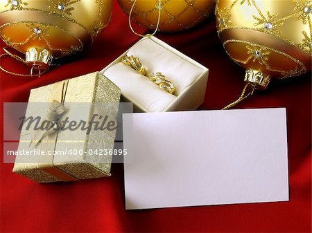 christmas decoration, diamond earrings and gift box  with seasonal greeting card