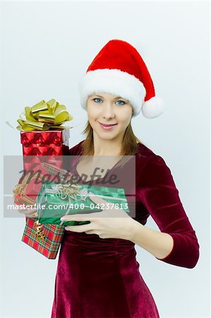 beautiful smiling girl in Santa hat with presents. Christmas