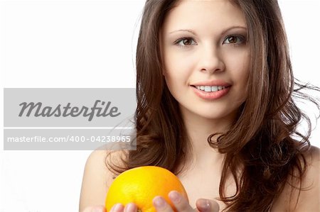 Beautiful young woman holding an orange. Close up