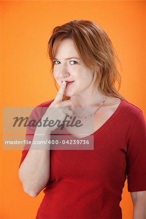 A middle-aged sexy woman with her finger to her lips