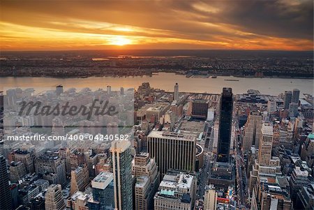 New York City Manhattan sunset skyline aerial view with office building skyscrapers and Hudson River.