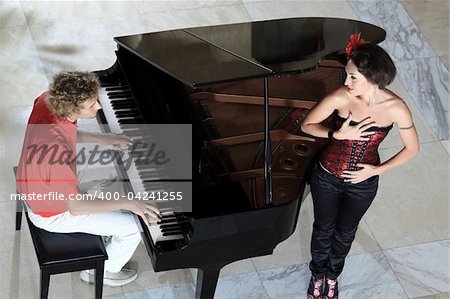 Handsome young man playing on the piano