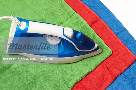 Flat smoothing iron on coloured bath towels