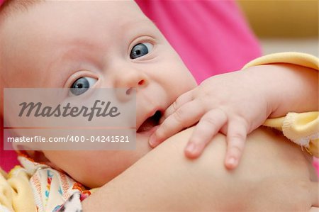 Little 4-month boy on mama's hands