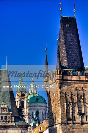 Famous church at one end of Charles bridge on the river in Prague.