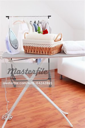 Basket with laundry and ironing board