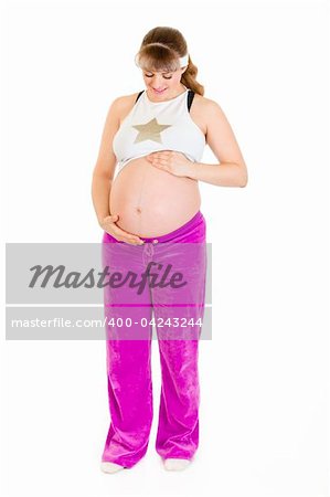 Pregnant woman in sportswear holding her belly isolated on white