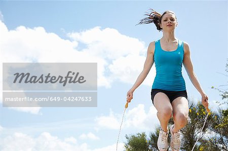 Woman jumping rope outdoors