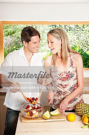 Couple cooking together in kitchen