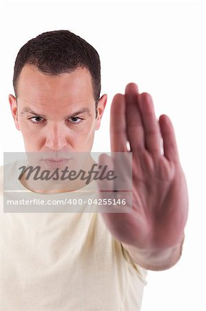 man with his hand raised in signal to stop