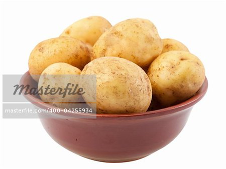 Many young potatoes in a clay bowl isolated on white background