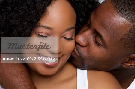 African american man kissing woman
