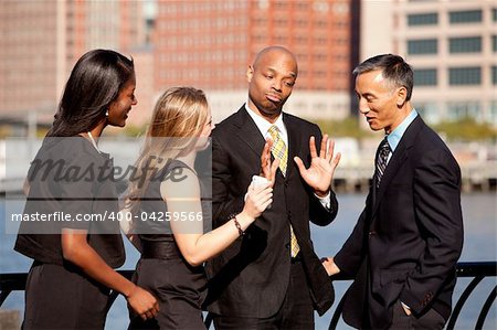 A group of business people outdoors in a discussion