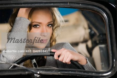 pretty young girl in an old car