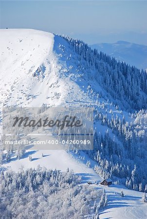 Winter in Slovak Mountains, hut at the foot of the hill