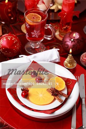 Place setting for Christmas with fresh fruits and hot wine punch