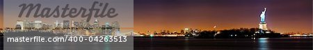 New York City night skyline panorama with Statue of Liberty over Hudson river with boat and skyscraper and colorful reflections.