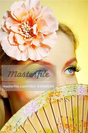 Close-up portrait of summer fashion creative eye make-up in yellow and green tones