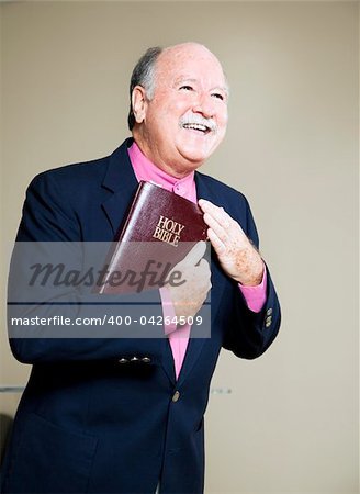 Happy minister holding the Bible and preaching a message of love.