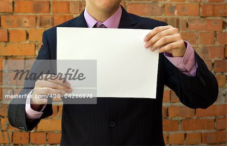 Business young man holding a blank white sheet of paper.
