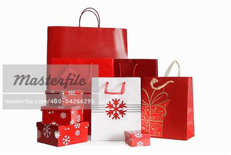 Various sizes of holiday shopping bags and gift boxes on white background