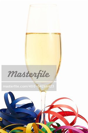 glass of champagne between streamer isolated on white background