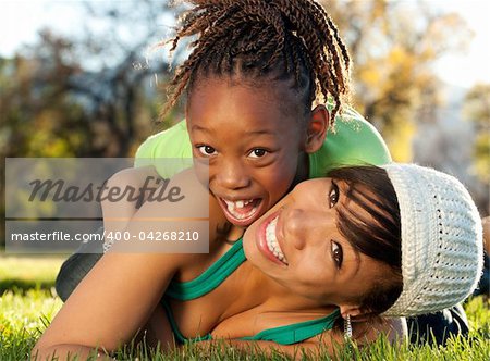 African American mother and child having fun spending time together in a park