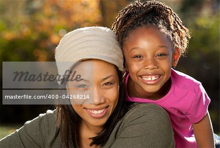 African American mother and child having fun spending time together in a park