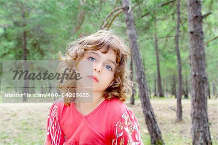 pensive girl in forest nature trees thinking gesture preschooler