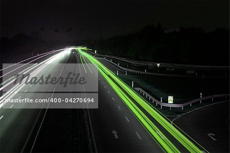 road with car traffic at night and blurry lights showing speed and motion