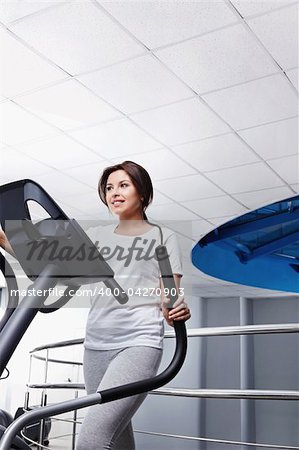 The young  girl on a exercise machine