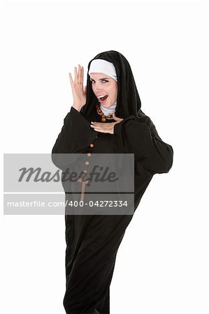 Young, attractive Catholic nun dancing on a white background