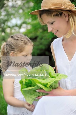 Young mother and daughter with lettuce